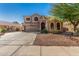 Attractive Southwestern home with arched windows, desert landscaping, and a two-car garage at 654 E Taylor Trl, San Tan Valley, AZ 85143