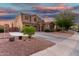 Beautiful two-story home with a three-car garage, long driveway, and desert landscaping at 654 E Taylor Trl, San Tan Valley, AZ 85143