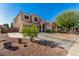 Beautiful two-story home with a three-car garage, long driveway, and desert landscaping at 654 E Taylor Trl, San Tan Valley, AZ 85143
