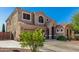 Charming two-story home with arched entry, desert landscaping, and neutral tones at 654 E Taylor Trl, San Tan Valley, AZ 85143