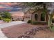 Beautiful two-story home with a three-car garage, long driveway, and desert landscaping at 654 E Taylor Trl, San Tan Valley, AZ 85143