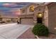 Close-up shot of a home's front entry featuring arched windows, decorative stonework, and desert landscaping at 654 E Taylor Trl, San Tan Valley, AZ 85143