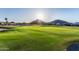 Scenic golf course view with desert landscaping and a mountain backdrop on a bright, sunny day at 654 E Taylor Trl, San Tan Valley, AZ 85143