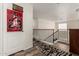 Second floor hallway with a basketball hoop on a bedroom door and wrought iron railing around the stairs at 654 E Taylor Trl, San Tan Valley, AZ 85143