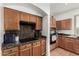 Kitchen featuring wood cabinets, granite countertops, and a functional cooking space at 654 E Taylor Trl, San Tan Valley, AZ 85143