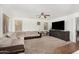 Bright living room with large sectional sofa, neutral walls and an entertainment center at 654 E Taylor Trl, San Tan Valley, AZ 85143