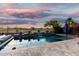 Backyard pool featuring a calming blue water, tiled surround, waterfall feature and views of the golf course at 654 E Taylor Trl, San Tan Valley, AZ 85143