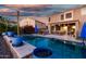 Sparkling backyard pool with lush landscaping and covered patio area at 654 E Taylor Trl, San Tan Valley, AZ 85143