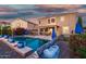 Backyard with a sparkling pool, patio, and covered outdoor seating area at 654 E Taylor Trl, San Tan Valley, AZ 85143