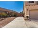 Side yard featuring a block wall and sidewalk leading to a fenced gate at 654 E Taylor Trl, San Tan Valley, AZ 85143