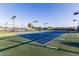 Well-maintained tennis court featuring blue and green playing surfaces, enclosed by a dark fence at 654 E Taylor Trl, San Tan Valley, AZ 85143
