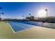 Bright tennis court with blue and green surfaces, set against a sunny sky and fenced perimeter at 654 E Taylor Trl, San Tan Valley, AZ 85143