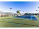 Several tennis courts with blue surfaces, fenced in and ready for play on a sunny day at 654 E Taylor Trl, San Tan Valley, AZ 85143