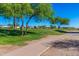 A charming walking path winds through the lush green landscaping in the community at 654 E Taylor Trl, San Tan Valley, AZ 85143