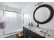 Bathroom featuring a granite vanity, large mirror, and walk-in shower at 6906 E 4Th St # 4, Scottsdale, AZ 85251