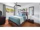 Cozy bedroom with a full-size bed, ceiling fan, and large window providing ample natural light at 6906 E 4Th St # 4, Scottsdale, AZ 85251