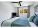 Comfortable bedroom with ceiling fan, television, and natural light from a window at 6906 E 4Th St # 4, Scottsdale, AZ 85251
