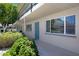 Charming condo exterior with a blue door and well-maintained landscaping, offering a welcoming curb appeal at 6906 E 4Th St # 4, Scottsdale, AZ 85251
