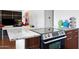 Close-up of a modern kitchen featuring granite countertops, an electric range, and sleek cabinets, blending style and functionality at 6906 E 4Th St # 4, Scottsdale, AZ 85251