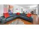Spacious living room with a blue sectional, colorful artwork, and an open layout, creating a stylish and functional area at 6906 E 4Th St # 4, Scottsdale, AZ 85251