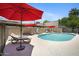 Inviting community pool with lounge chairs and red umbrellas, offering a perfect spot for relaxation and recreation at 6906 E 4Th St # 4, Scottsdale, AZ 85251