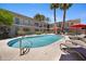 Serene community pool with inviting lounge chairs and umbrellas, ideal for relaxation in a lush setting at 6906 E 4Th St # 4, Scottsdale, AZ 85251