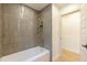 Bathroom showcases stylish gray tiling around the tub and shower with bronze fixtures at 7127 N 79Th St, Scottsdale, AZ 85258