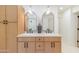 Bright bathroom featuring a double vanity with modern sinks and stylish arched mirrors at 7127 N 79Th St, Scottsdale, AZ 85258
