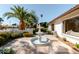 Charming front yard with tiled patio, palm tree, and elegant tiered fountain, creating a welcoming outdoor space at 7127 N 79Th St, Scottsdale, AZ 85258