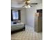 This bedroom features a ceiling fan, window with blinds, and tile flooring at 717 W Lynwood St, Phoenix, AZ 85007