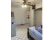 This bedroom has tile floors, a ceiling fan, and a closet for storage at 717 W Lynwood St, Phoenix, AZ 85007