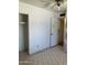This bedroom features a closet, door, and tile flooring at 717 W Lynwood St, Phoenix, AZ 85007