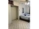 A bedroom features tile flooring, a built-in closet, and a bed at 717 W Lynwood St, Phoenix, AZ 85007