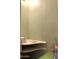 A small room features a corner shelf, offering an area for storage or customization at 717 W Lynwood St, Phoenix, AZ 85007