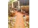 A pathway leading to a charming home, surrounded by lush vegetation and showing its inviting entrance at 717 W Lynwood St, Phoenix, AZ 85007