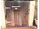 Rustic wooden gate featuring a mailbox and sturdy hardware, enhancing the property's entry point at 717 W Lynwood St, Phoenix, AZ 85007