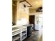 An in-progress kitchen displays vintage flooring, a black range, and potential renovation opportunities at 717 W Lynwood St, Phoenix, AZ 85007