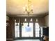 Living room with chandelier and large window, showcasing the room's potential for renovation and personalization at 717 W Lynwood St, Phoenix, AZ 85007