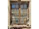 Vintage window with distressed frame and aged glass, offering a glimpse into the home's historic character at 717 W Lynwood St, Phoenix, AZ 85007
