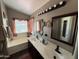 The bathroom features dual sinks, and a tub under a window with curtains at 723 W Milada Dr, Phoenix, AZ 85041