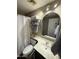 This cozy bathroom offers a mirrored vanity, toilet, and shower with updated fixtures at 723 W Milada Dr, Phoenix, AZ 85041