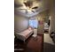 The cozy bedroom features a ceiling fan, pink rug, and built-in shelves at 723 W Milada Dr, Phoenix, AZ 85041