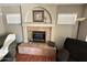 Cozy fireplace with a tile surround and mantle in the living room at 723 W Milada Dr, Phoenix, AZ 85041