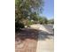 Landscaped front yard with desert accents and mature trees at 723 W Milada Dr, Phoenix, AZ 85041