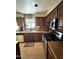 Efficient kitchen layout with dark wood cabinets and stainless steel appliances at 723 W Milada Dr, Phoenix, AZ 85041