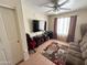 The living room has a tv, couch, rug and ceiling fan at 723 W Milada Dr, Phoenix, AZ 85041