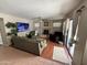 Inviting living room features a cozy fireplace, neutral-toned walls and access to the backyard at 723 W Milada Dr, Phoenix, AZ 85041
