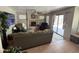 Spacious living room with fireplace, ceiling fan, and sliding glass door to the patio at 723 W Milada Dr, Phoenix, AZ 85041