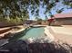 Backyard features a private pool with a charming waterfall and an outdoor kitchen area at 723 W Milada Dr, Phoenix, AZ 85041