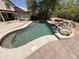 This backyard features an in-ground pool with rock waterfall and plenty of patio space for entertaining at 723 W Milada Dr, Phoenix, AZ 85041